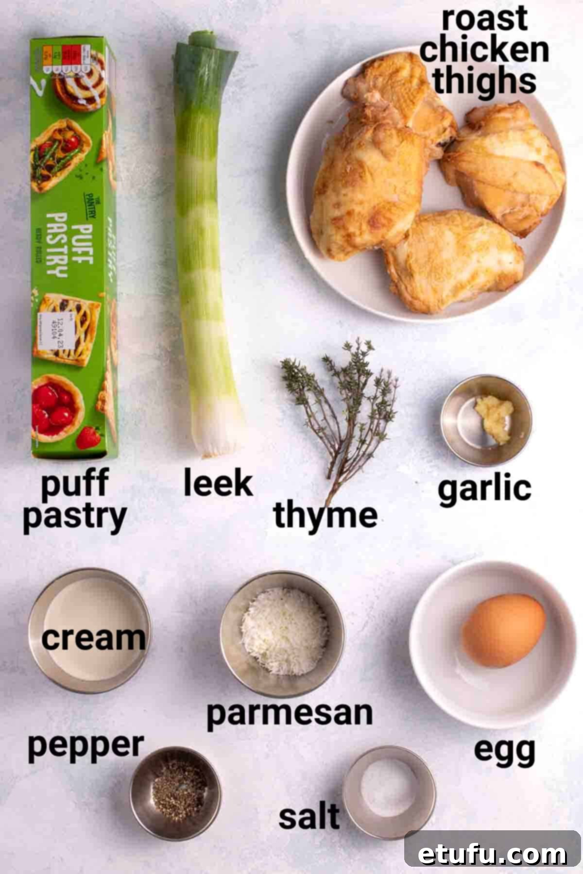 Golden Flaky Creamy Chicken Leek Pies 4 Close-up of ingredients for creamy chicken and leek pies, including chicken, leeks, cream, and parmesan.