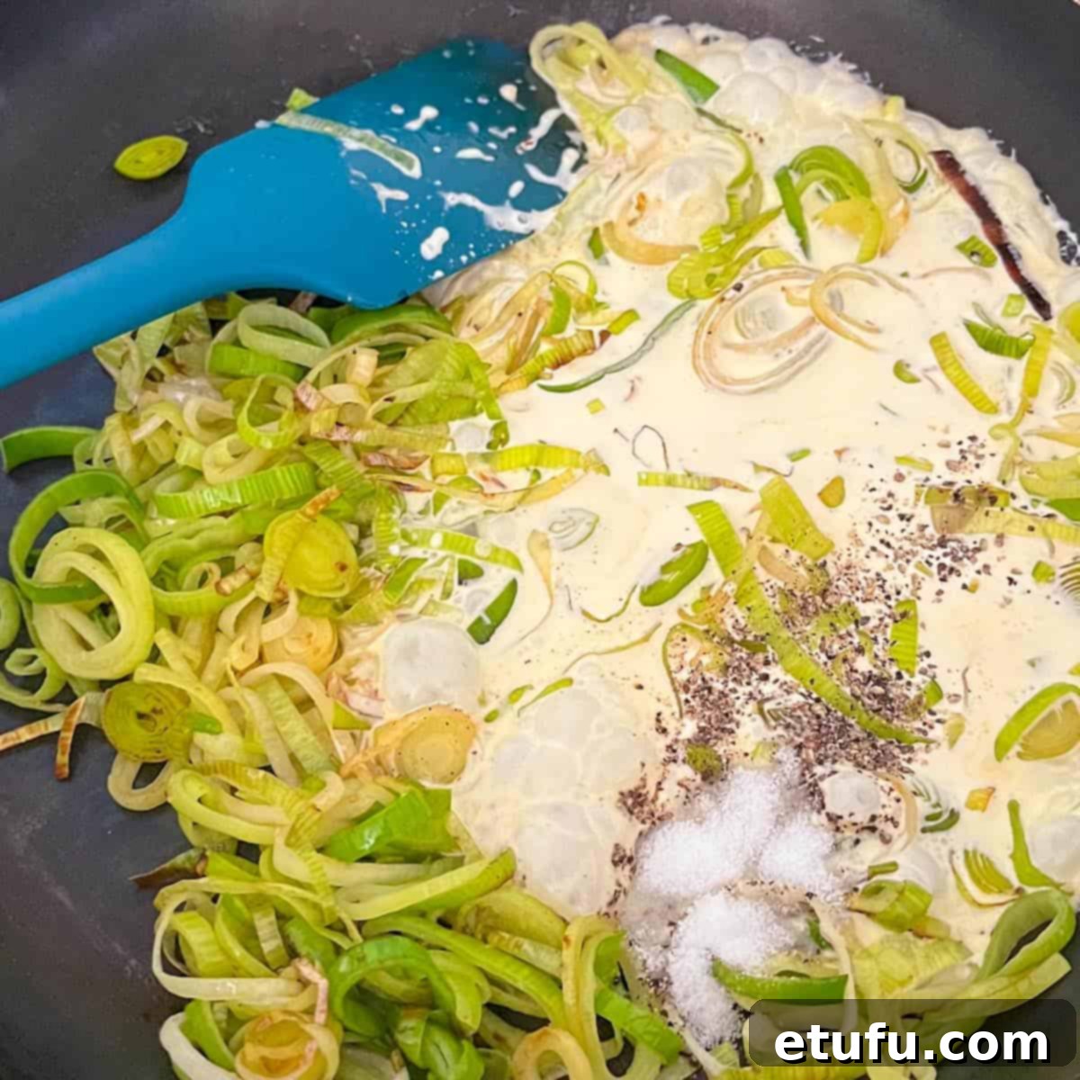 Golden Flaky Creamy Chicken Leek Pies 8 Pouring double cream into a frying pan with softened leeks.