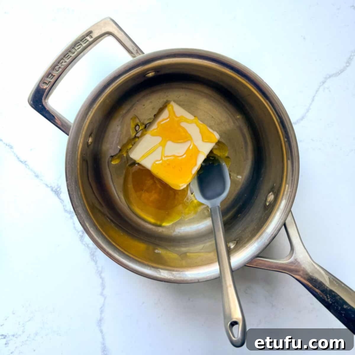 Adding the butter, golden syrup and vanilla to a small saucepan.