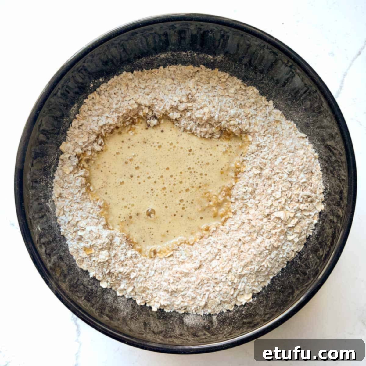 Adding the butter mixture to the dry ingredients.