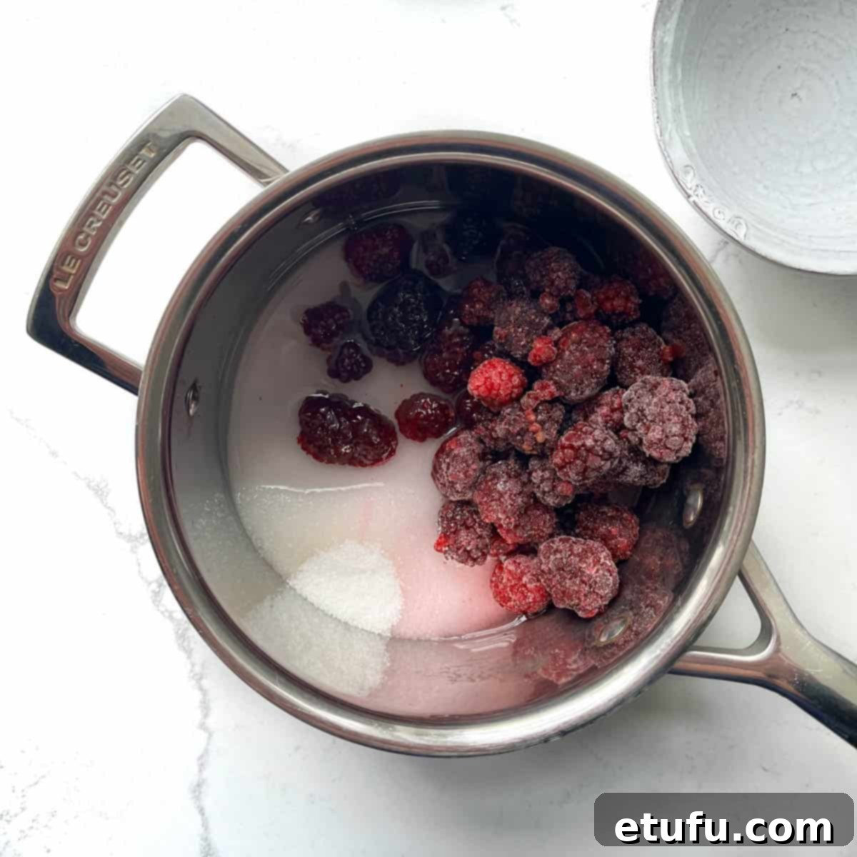 Blackberries, water and sugar added to a saucepan.