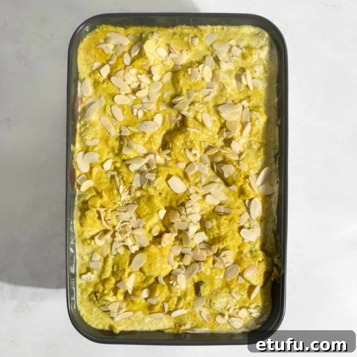 Crispy flaked almonds are scattered over the creamy Pasanda curry, adding a delightful crunch and garnish.