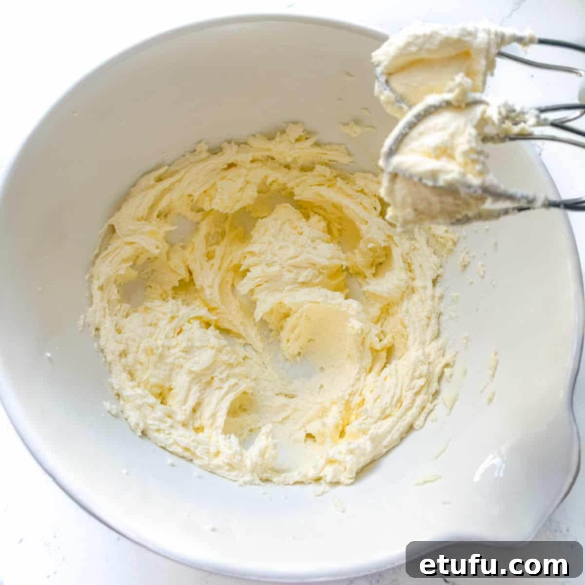 The butter and sugar mixture, now light in color and creamy in texture after being thoroughly beaten.