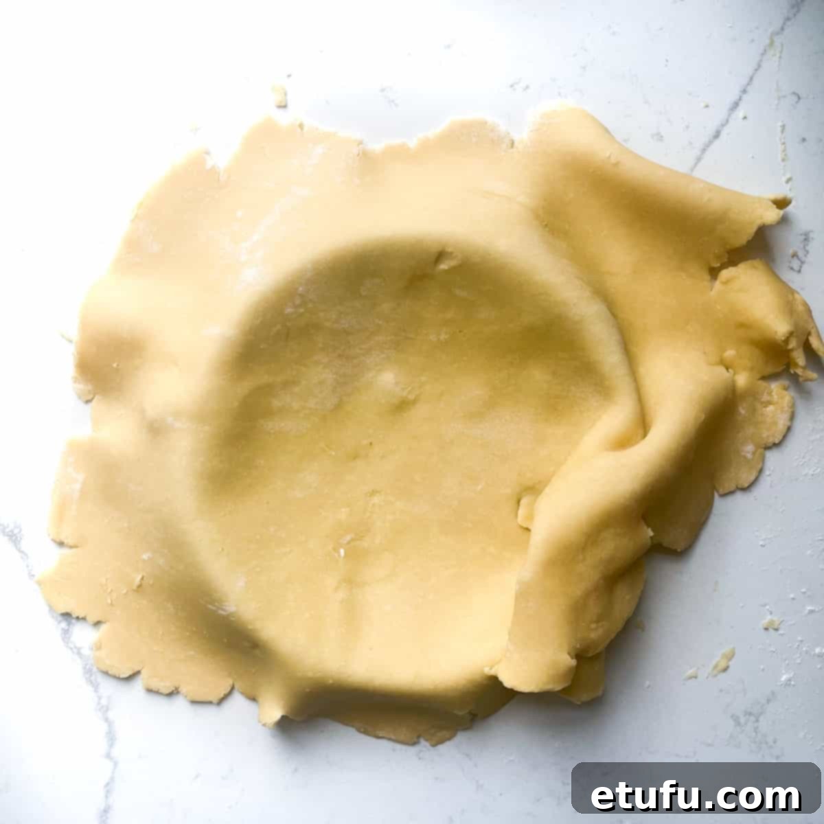 Exquisite French Fruit Tart 15 Draping the pastry into the tart case.