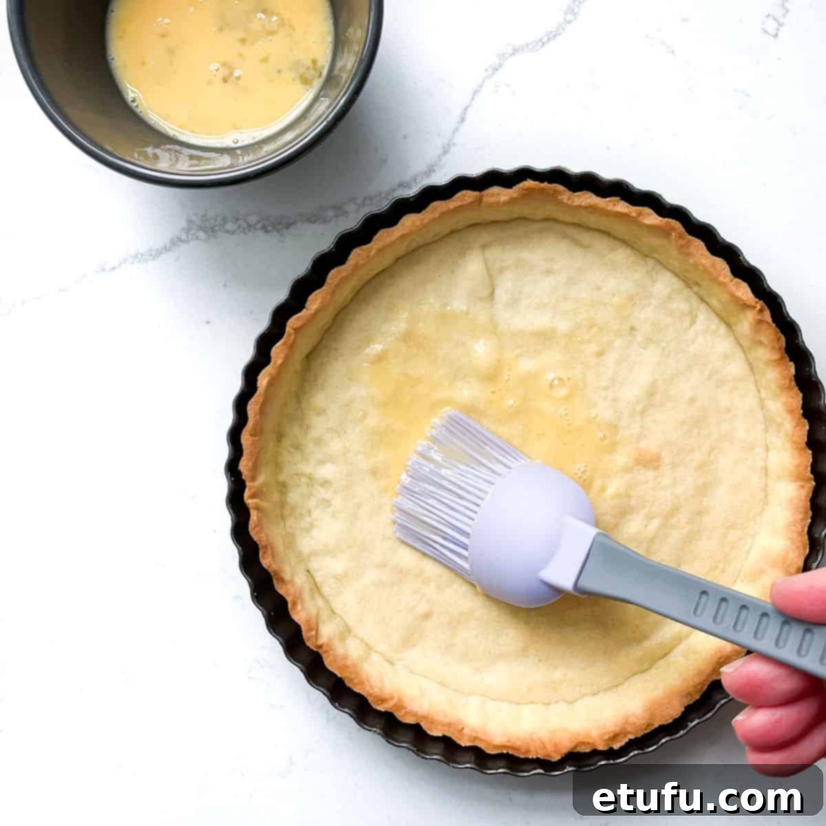 Exquisite French Fruit Tart 24 Painting on an egg wash onto the baked pastry case.