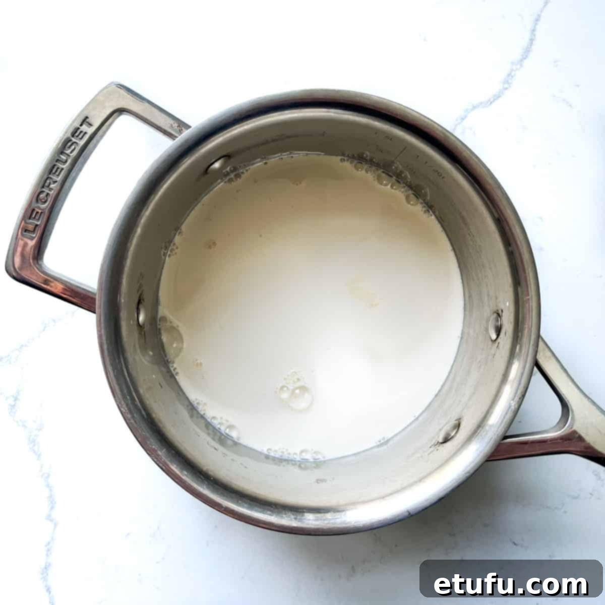 Exquisite French Fruit Tart 29 Adding milk, cream and salt to a small saucepan.