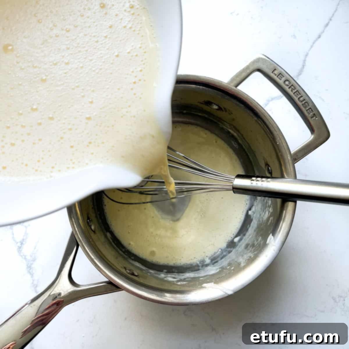 Exquisite French Fruit Tart 32 Adding the creme pattisiere mixture back into a saucepan.
