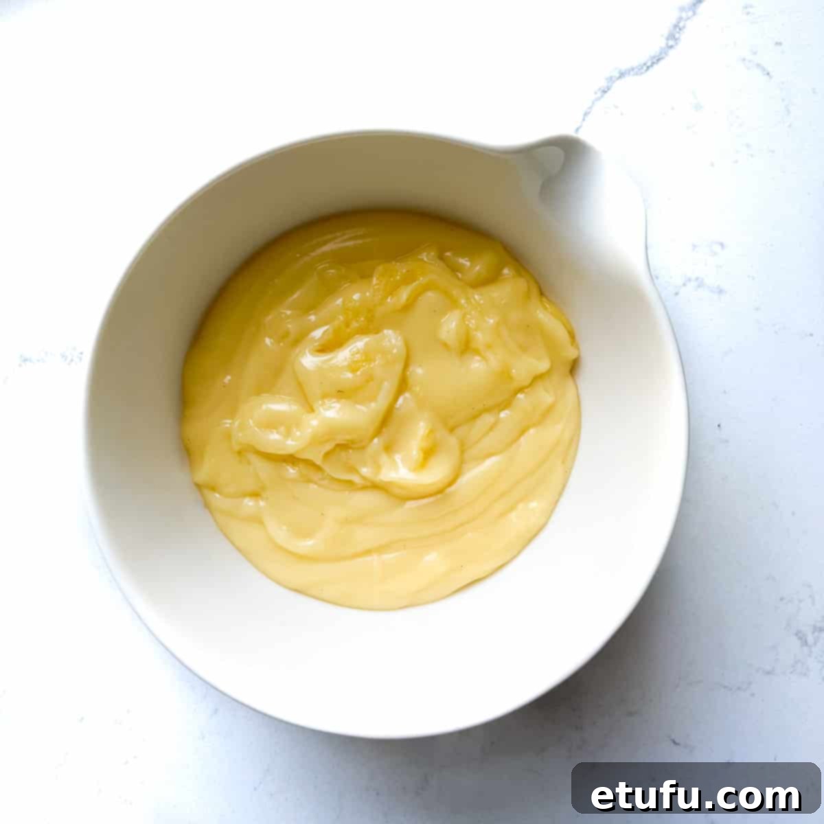 Exquisite French Fruit Tart 36 Creme pattisiere in a white mixing bowl.