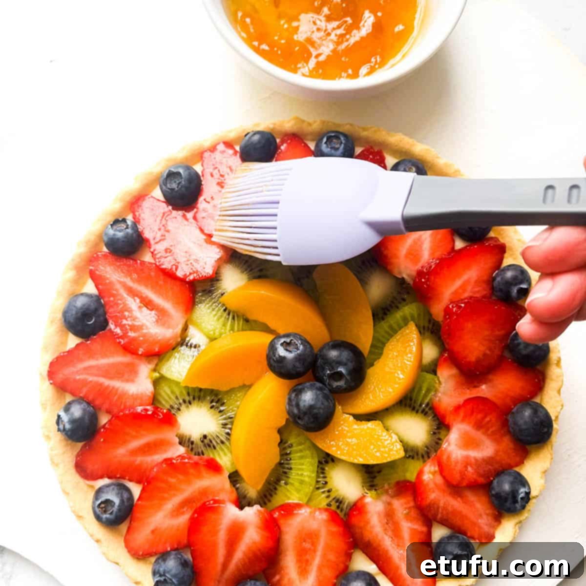 Exquisite French Fruit Tart 40 Brushing warm apricot jam onto the fruits for a tarte aux fruits.