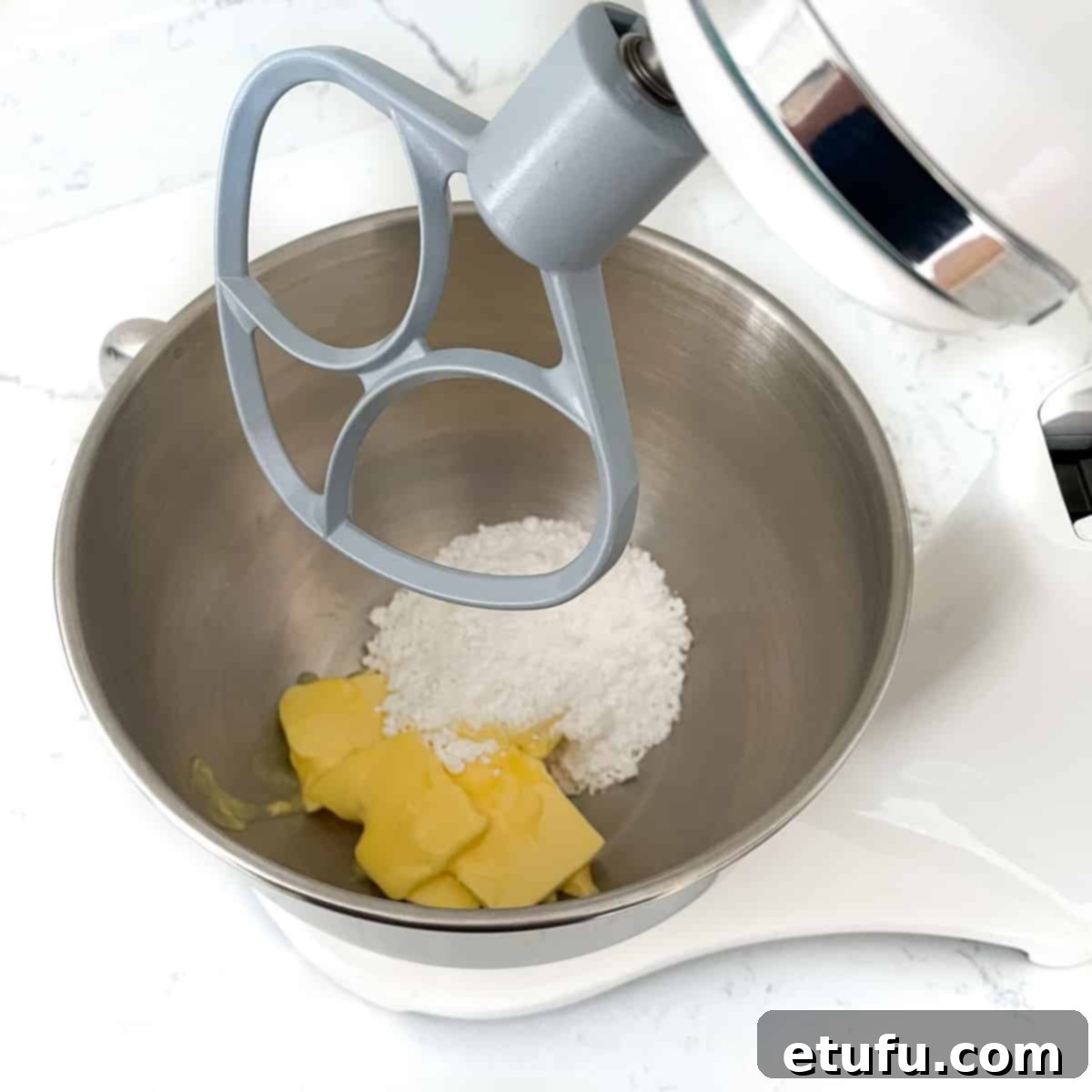 Exquisite French Fruit Tart 6 Adding butter and sugar to the bowl of a stand mixer.