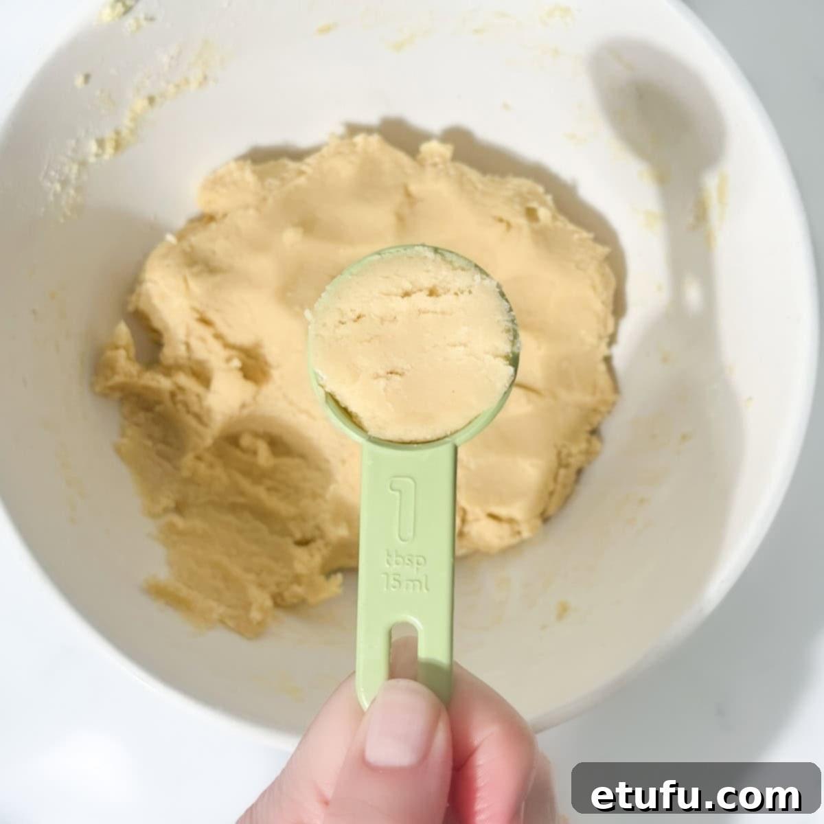 A tablespoon of dough from the thumbprint with icing cookie dough.