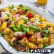Creamy italian pasta salad in a rectangular enamel bowl.