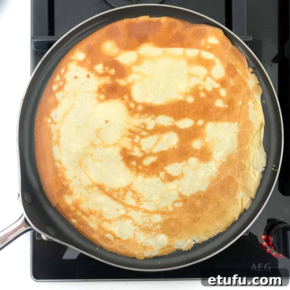A flipped over pandekager in a pancake frying pan.
