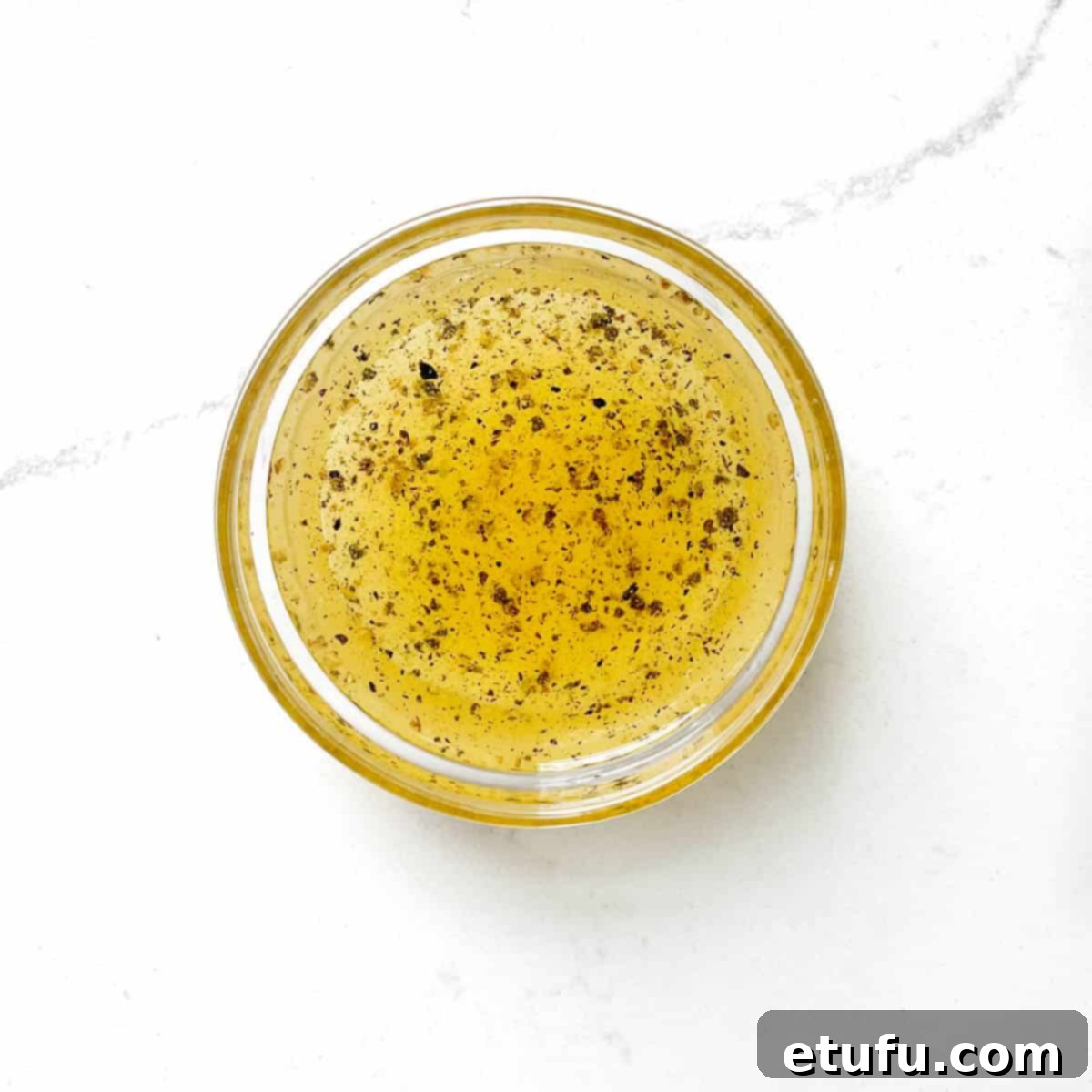 The salad dressing for taboule in a small mixing bowl.