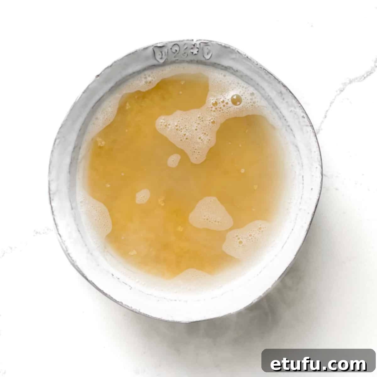 Adding boiling water to the bulgur wheat for soaking.