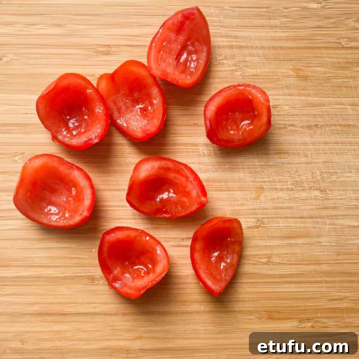 Sliced tomatoes on a chopping board.