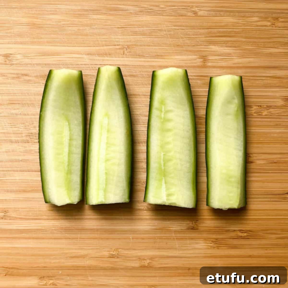 Sliced cucumber on a chopping board.