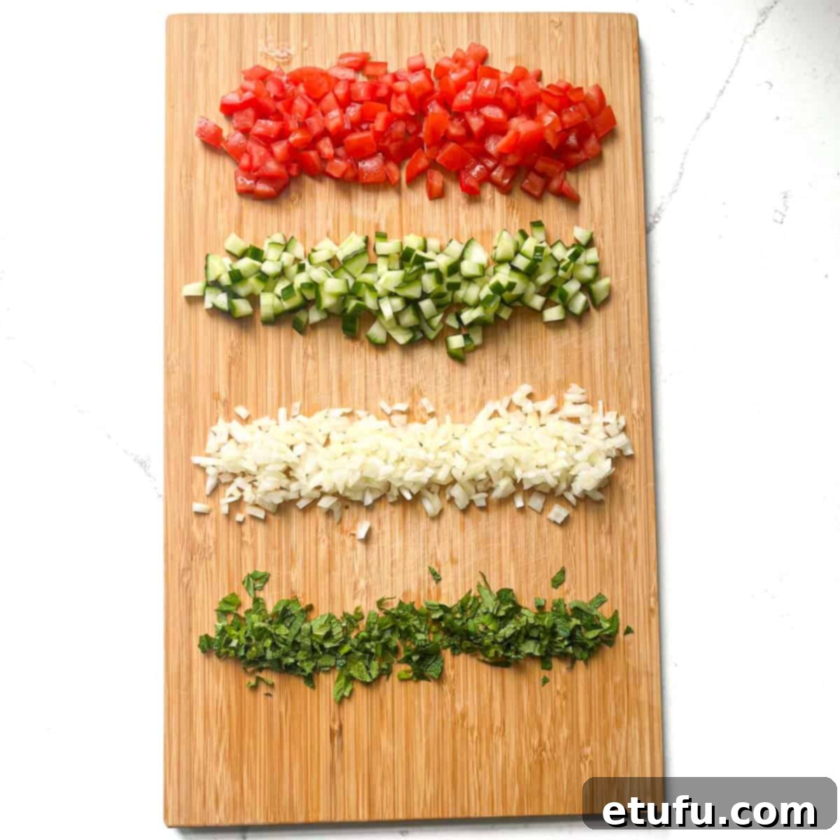 All the veg and herbs on a chopping board for the Taboule.