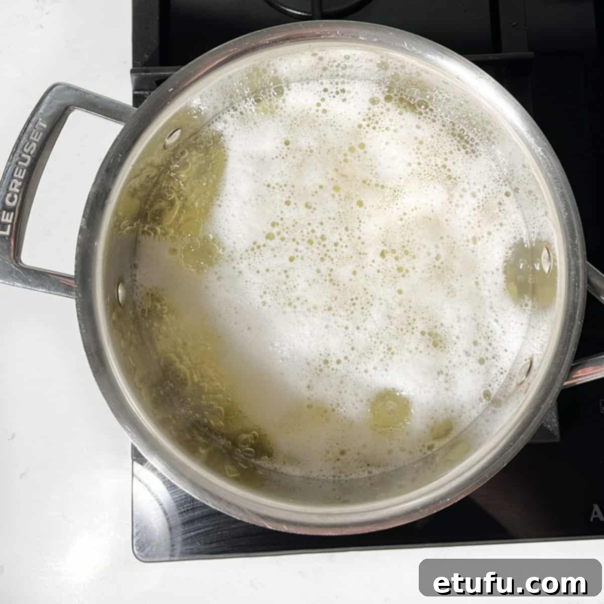 Potato cubes in a saucepan, brought up to a rolling bowl.
