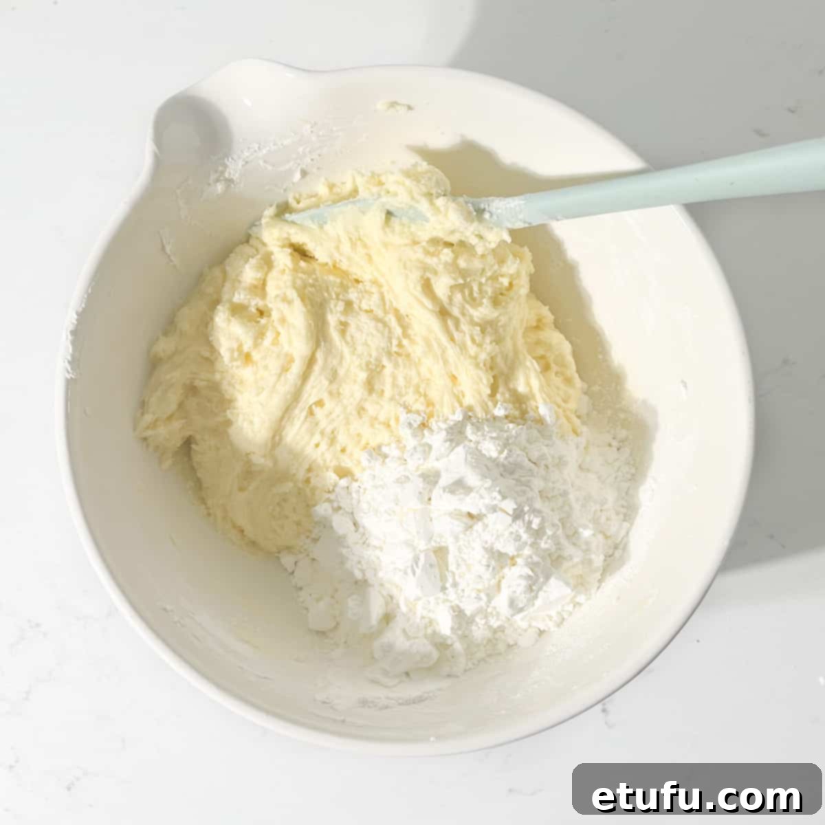 Adding cornstarch to the butter and condensed milk mixture.