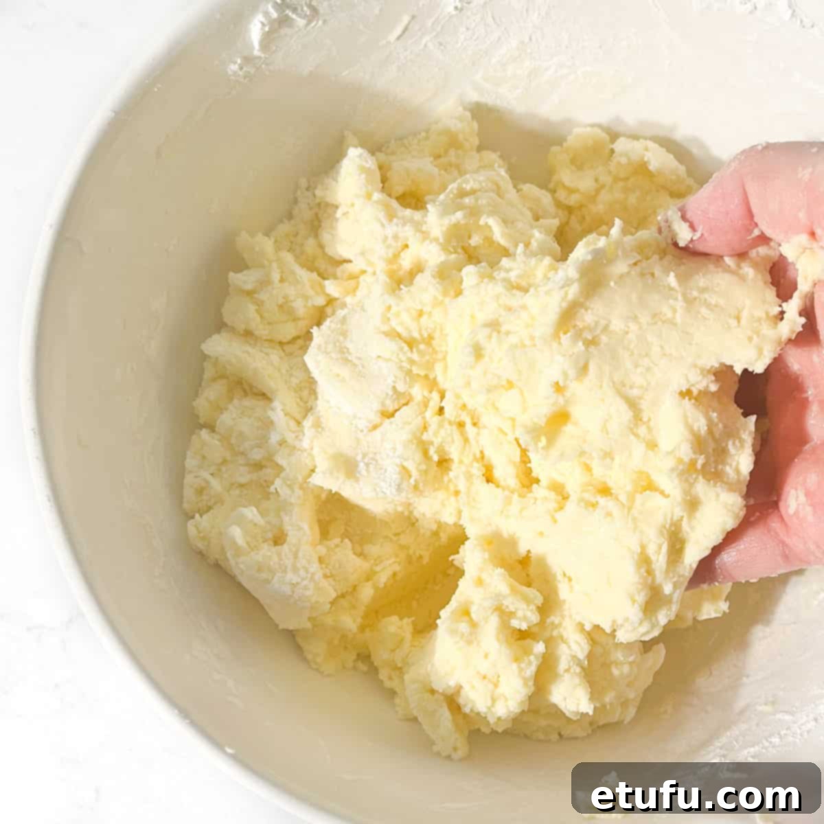 Mixing the cornflour into the dough mixture by hand.