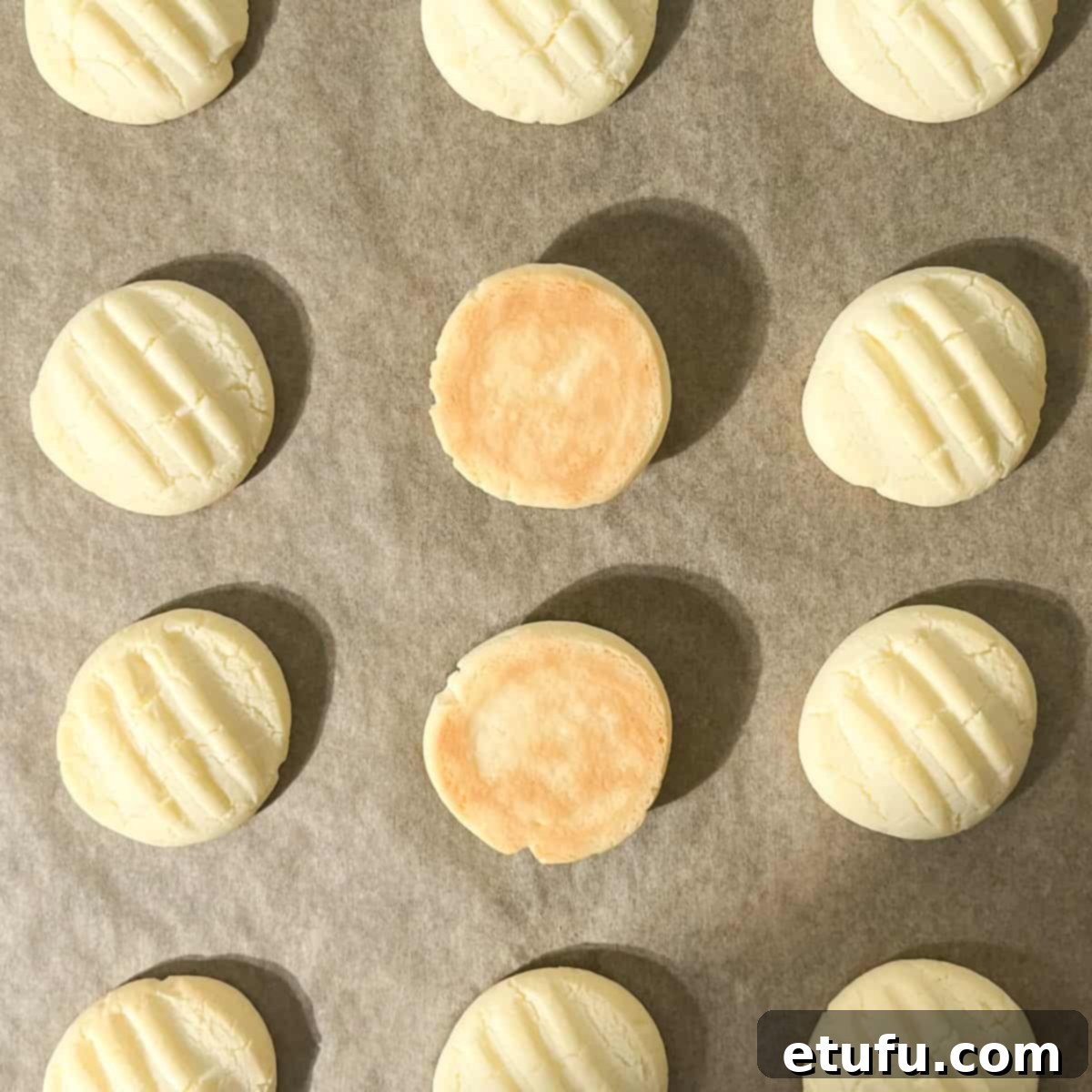 The golden brown undersides of two sequuilho cookies.