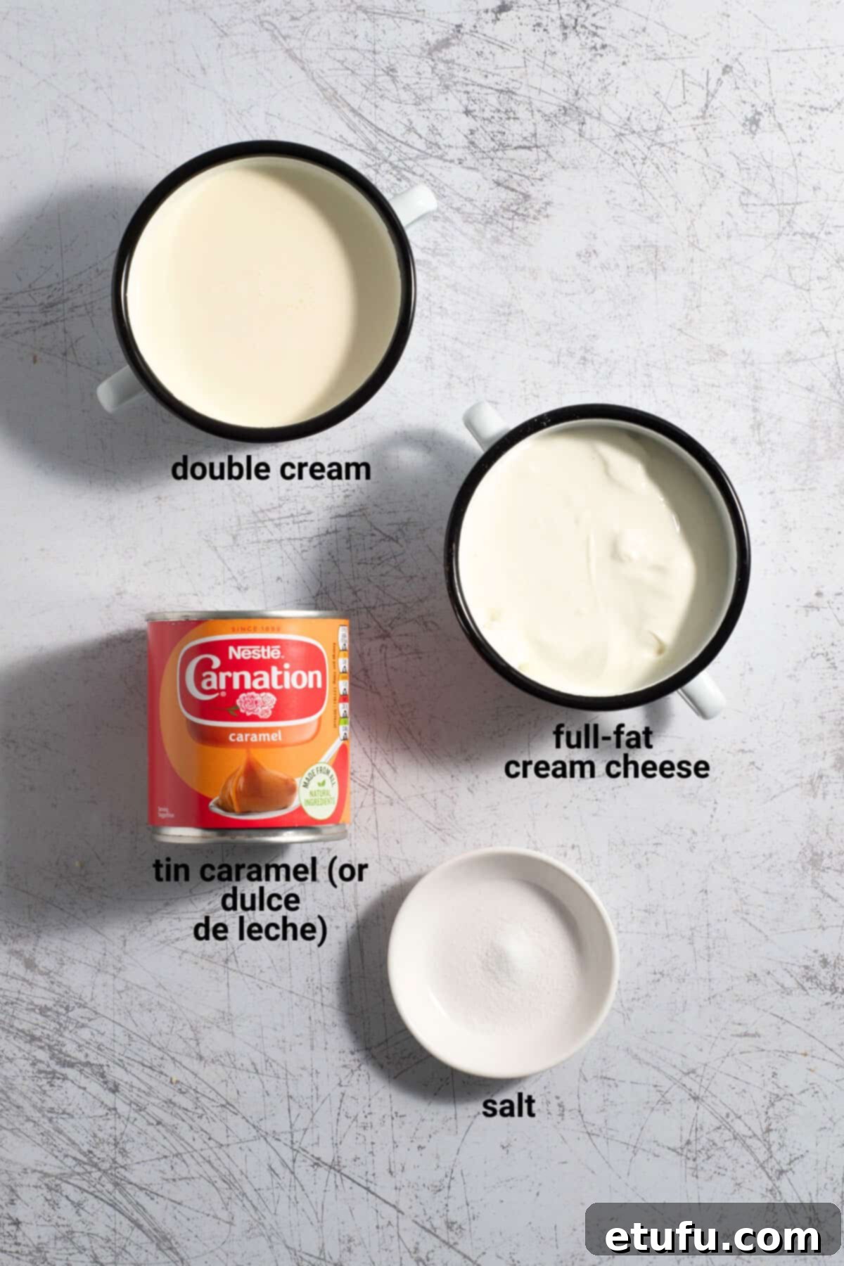 Individual ingredients for dulce de leche mousse laid out: dulce de leche, cream cheese, double cream, and a small bowl of salt.
