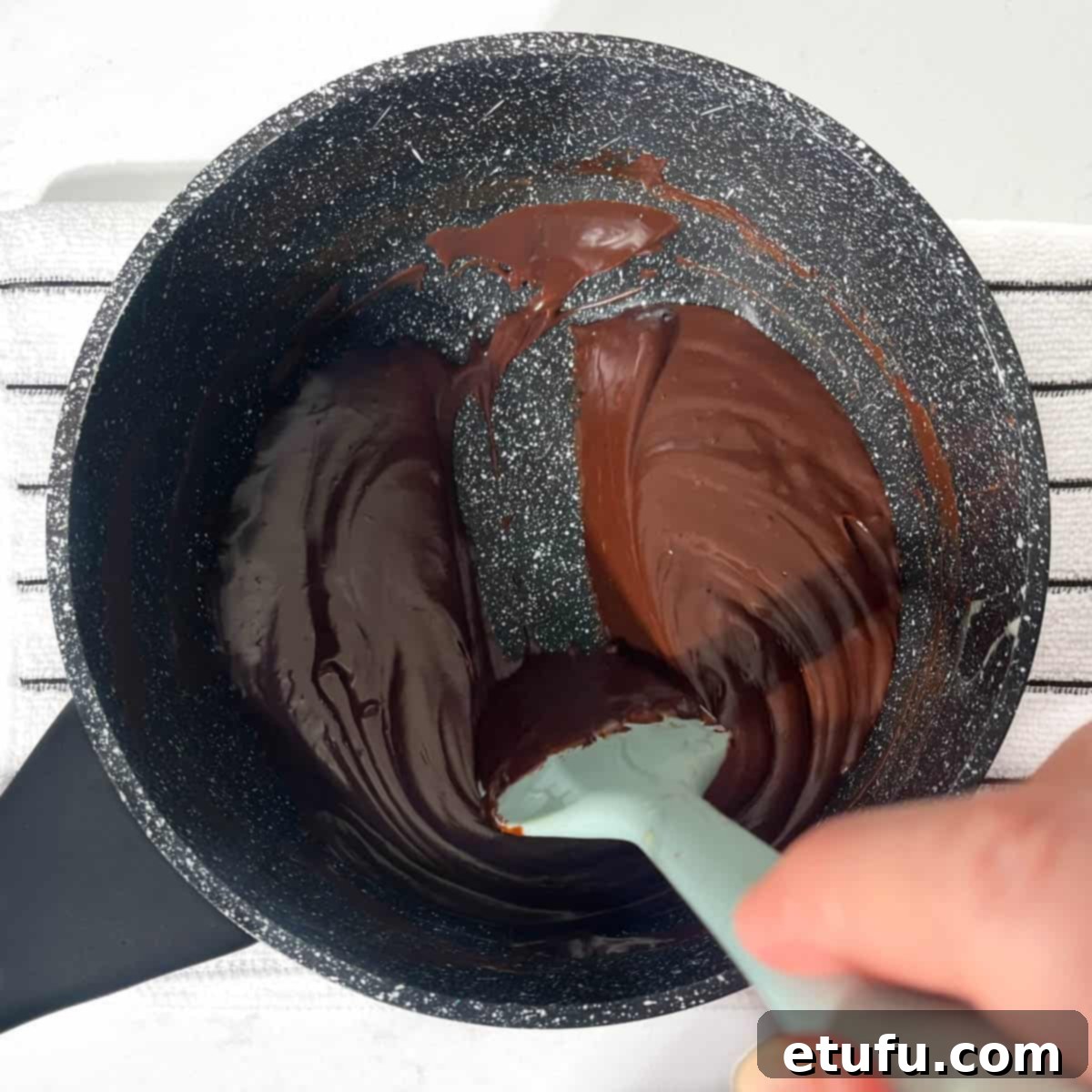 Dragging a spatula through the brigadeiro mixture leaving a thick, clear line on the bottom of the saucepan. 