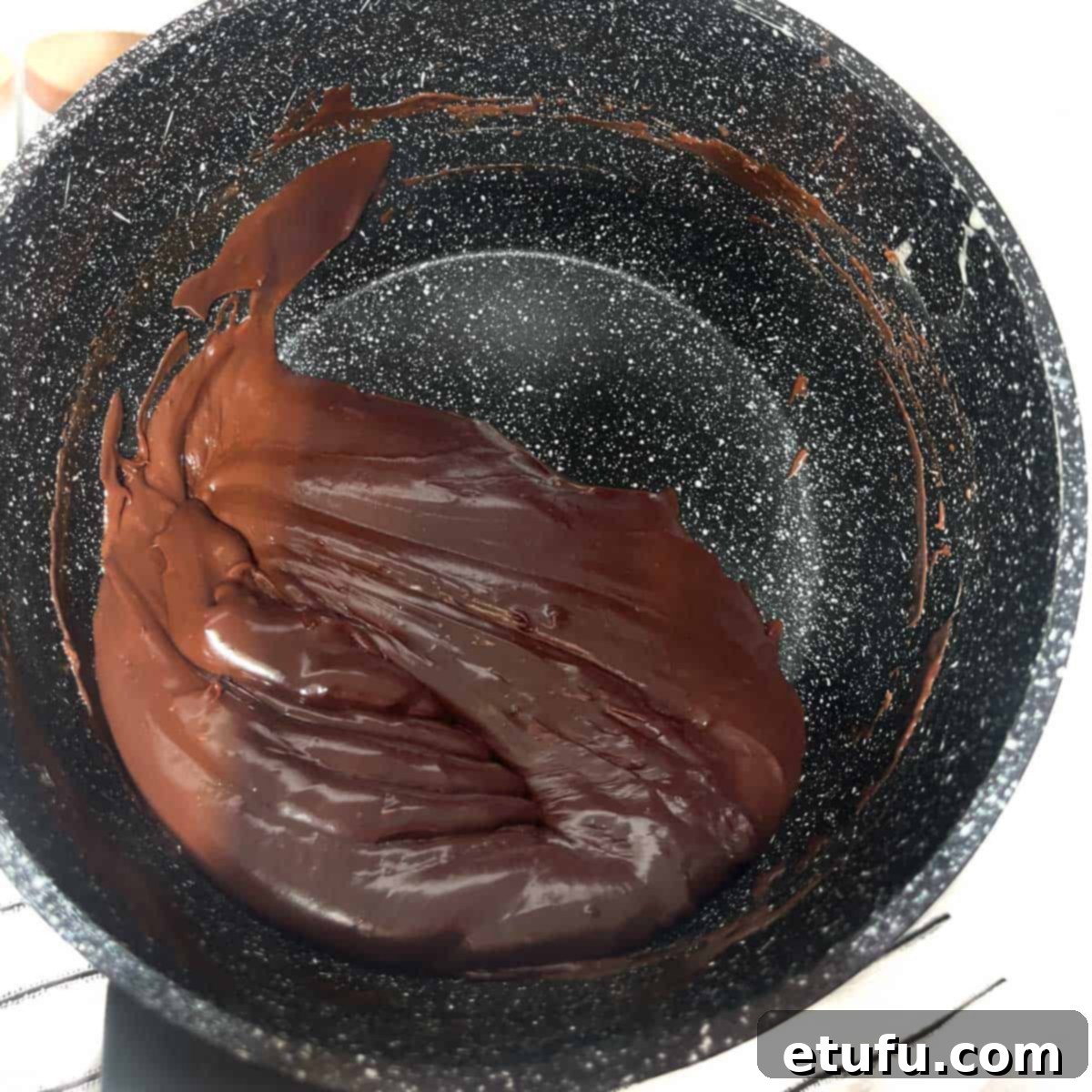 Brigadeiro mixture pulling away from the sides in a saucepan.