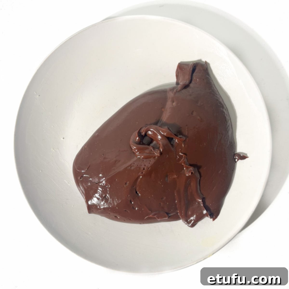 Brigadeiro mixture tipped out on a white plate.