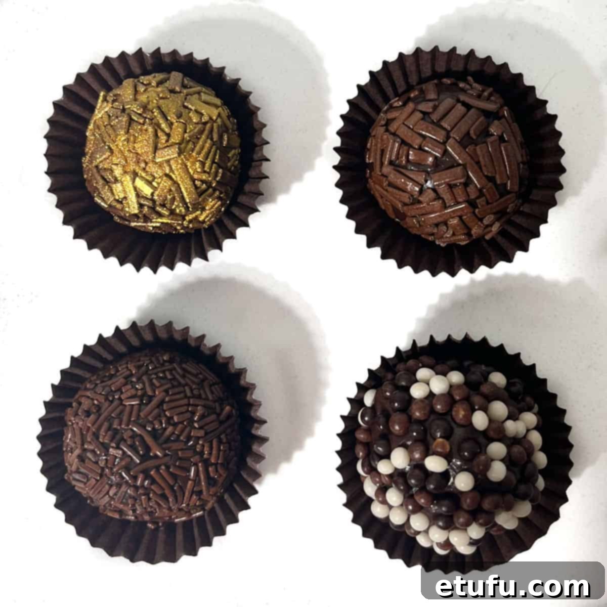 Four brigadeiros in paper cases, all with different sprinkles.