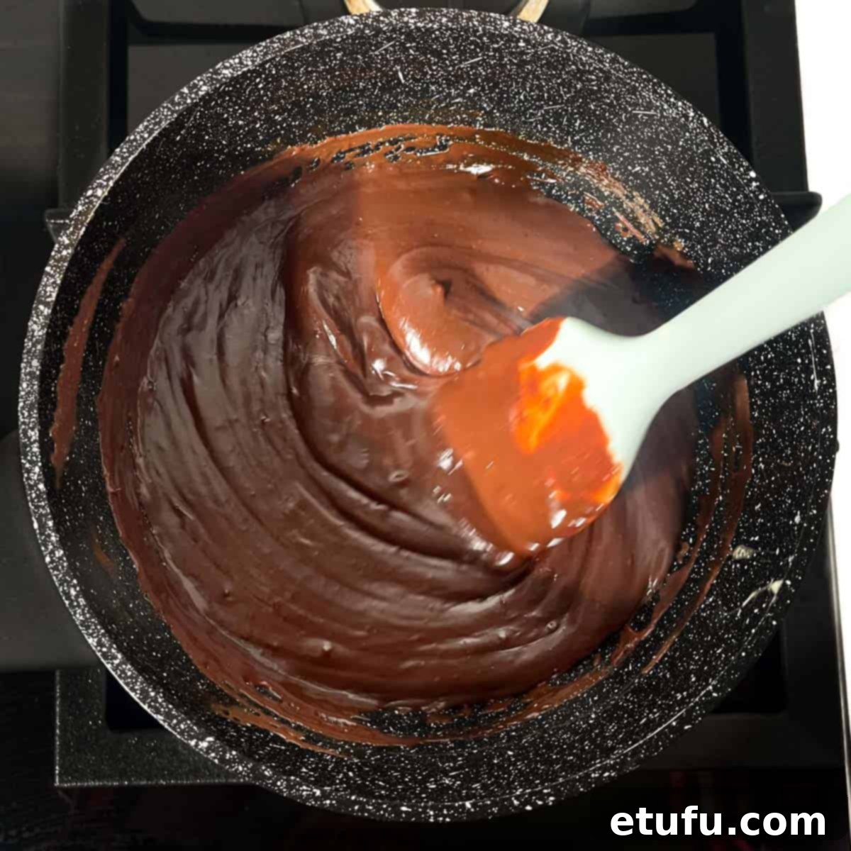 Mixture being stirred until it looks glossy and smooth.