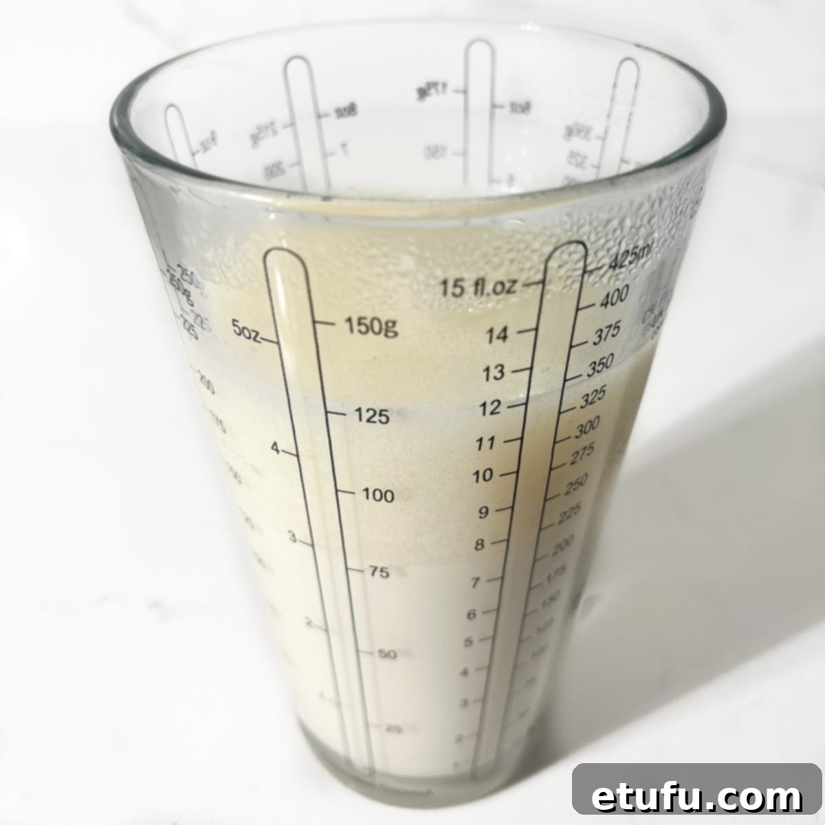 Oil and milk mixed in a measuring jug.