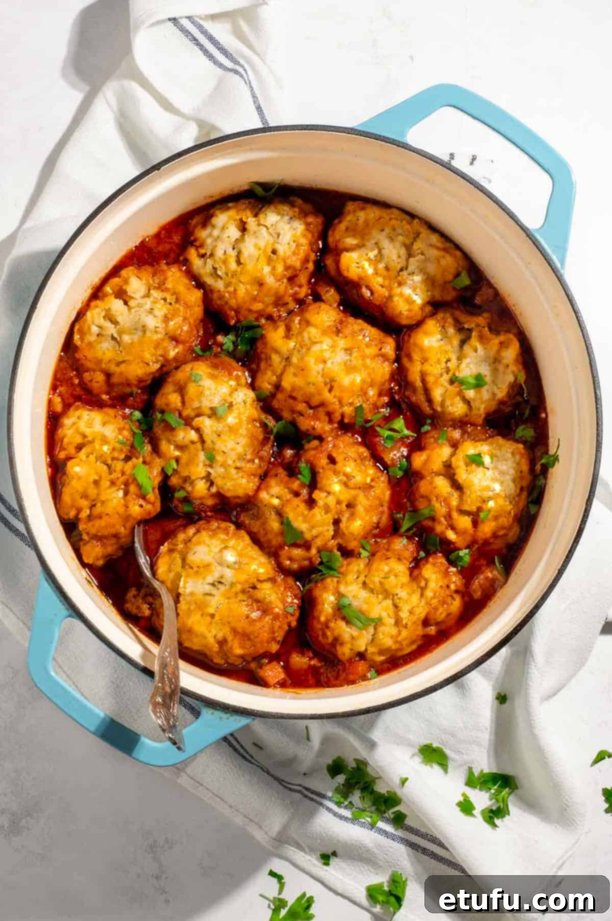 A casserole pot with mince and dumplings.