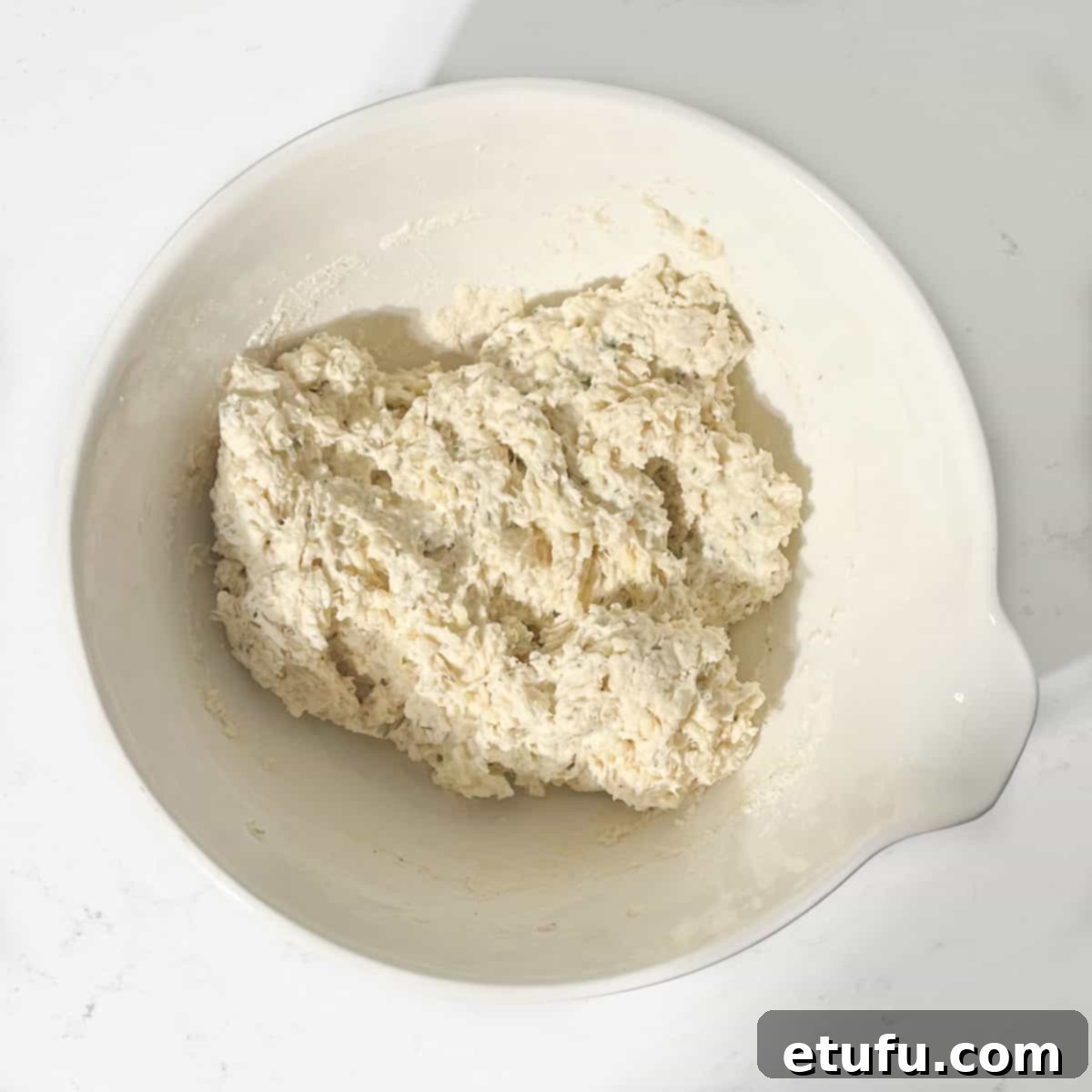 Dumpling mixture in a large white bowl for the Mince and Dumplings.