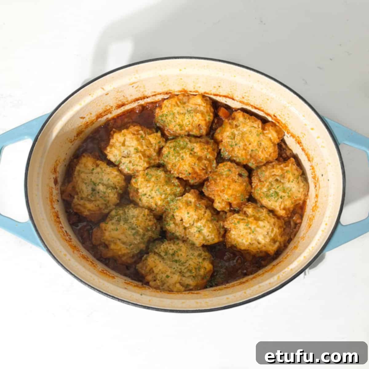 Cooked mince and dumplings in a large pot.