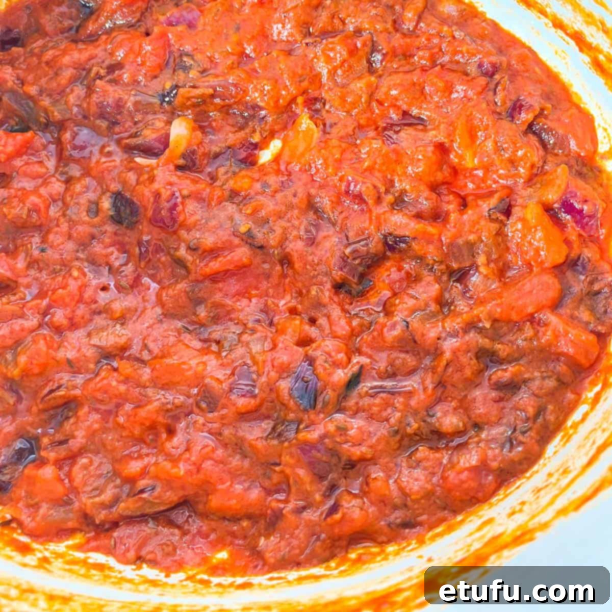 A close up of the tomato base for the chicken handi, showing how the oil is surfacing through the reduved tomatoes.
