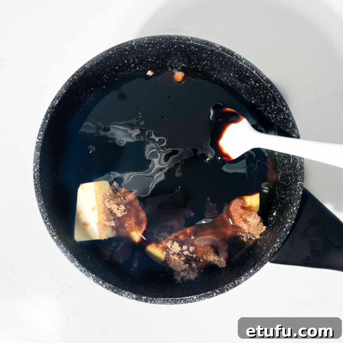 Adding the butter, sugars and syrups to a saucepan for the Jamaican Ginger cake.