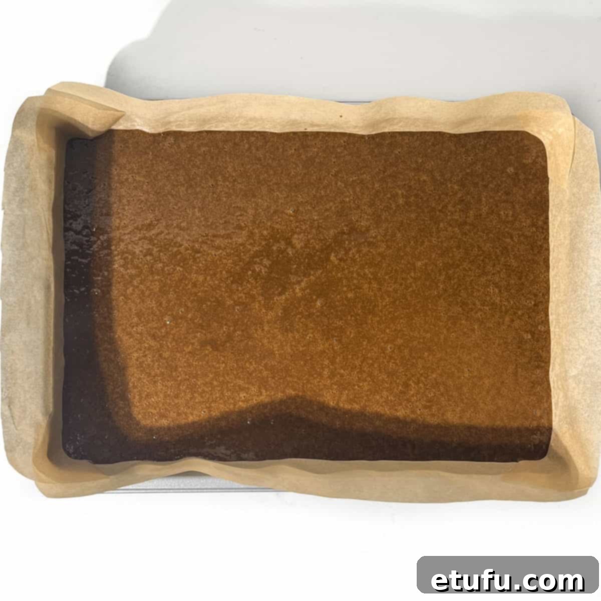 Jamaican ginger cake batter in a baking tin.