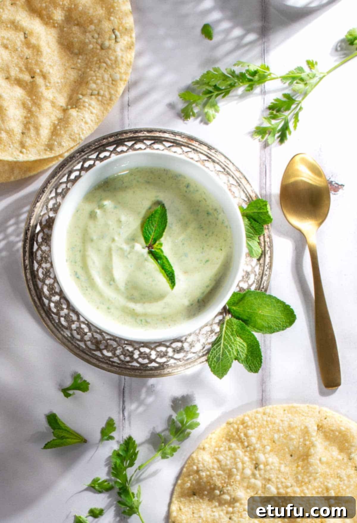 Indian mint sauce in a white bowl, garnished with fresh mint.