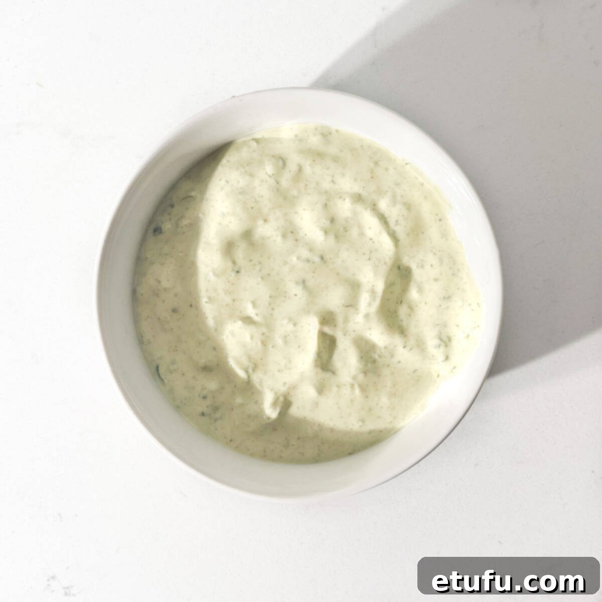 Finished Indian mint sauce in a small white bowl, ready to serve.