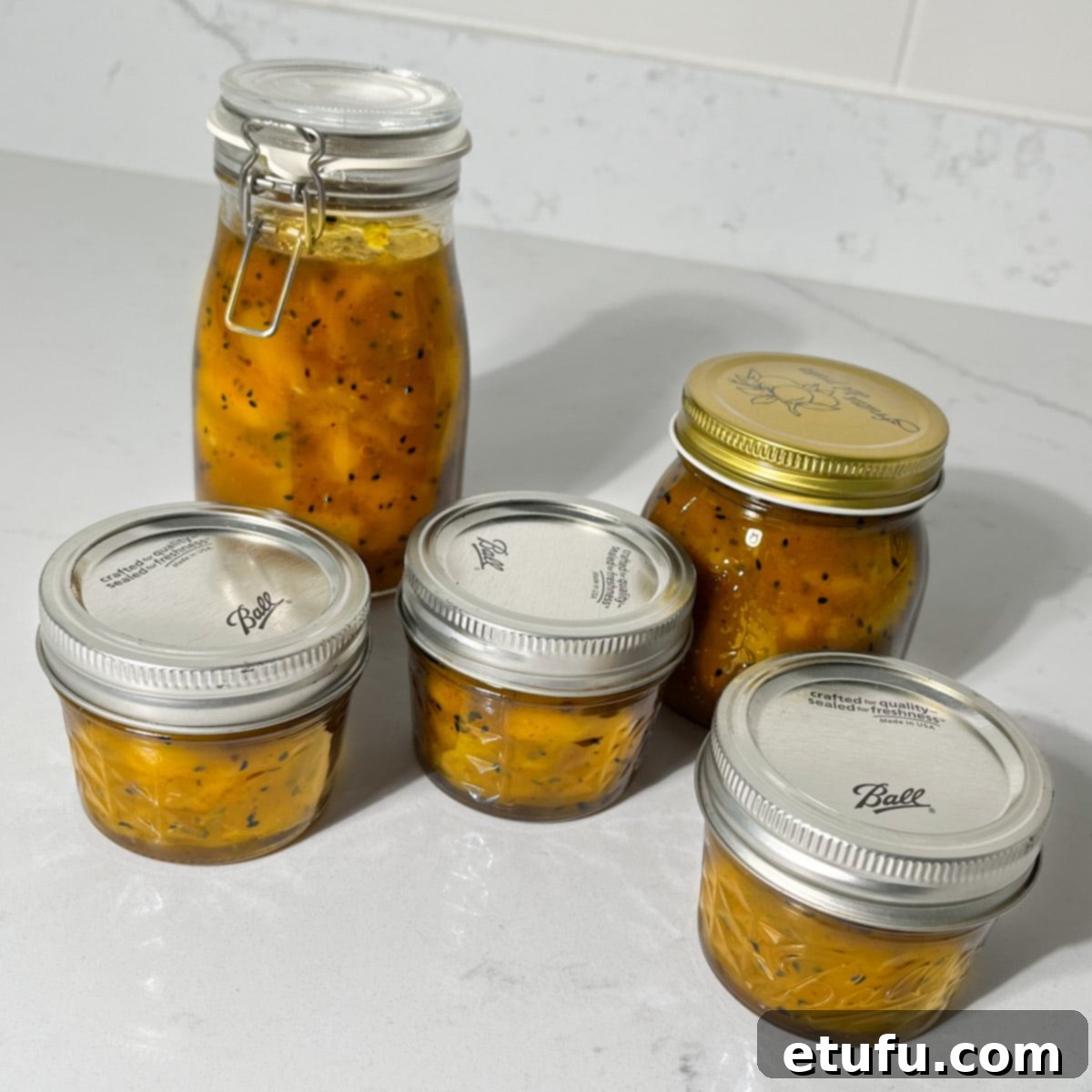 Five jars of Indian mango chutney.