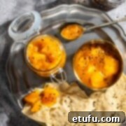 Indian mango chutney in a jar and a bowl with some poppadoms on a plate.