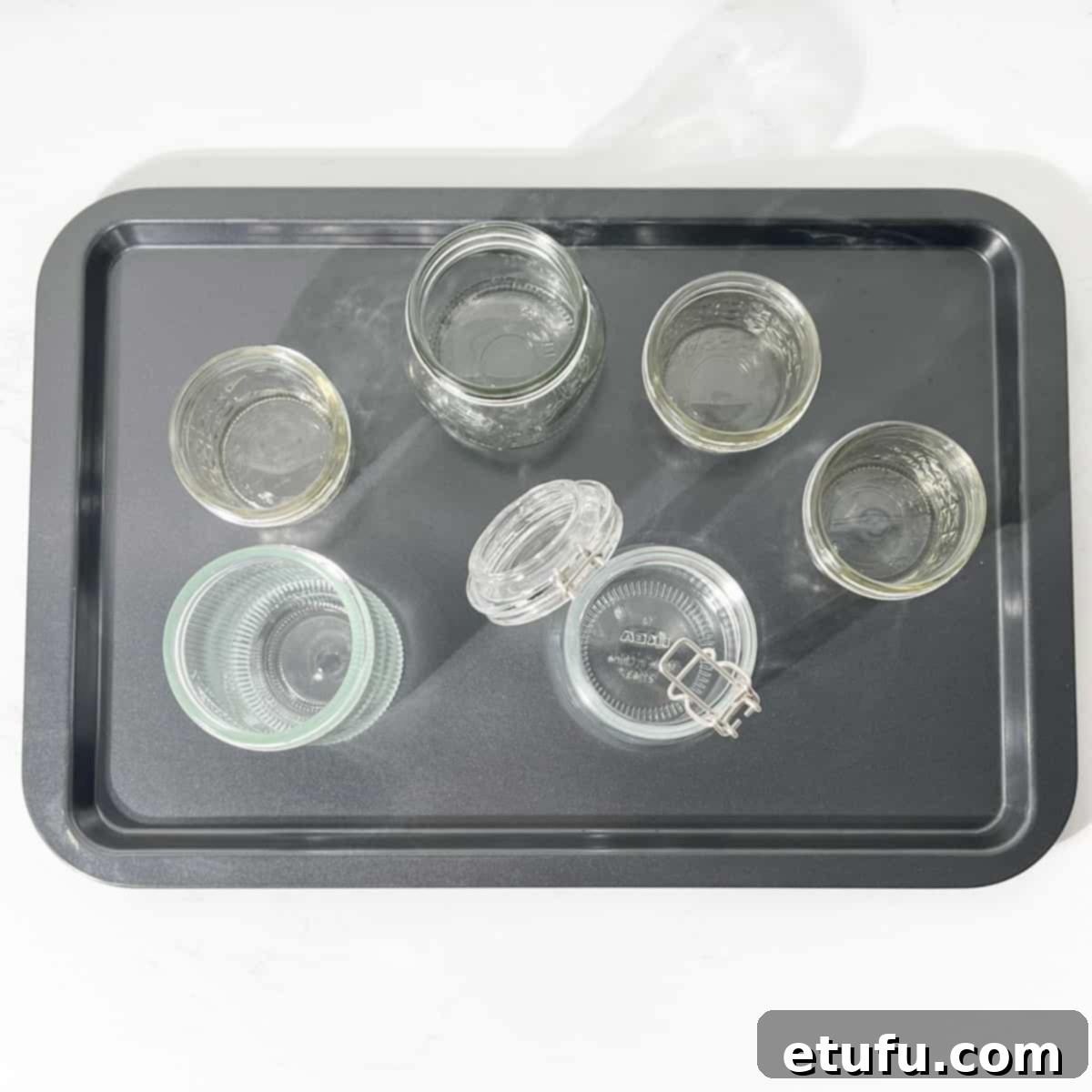 Bottles on a baking tray ready to go into the oven for sterilisation.