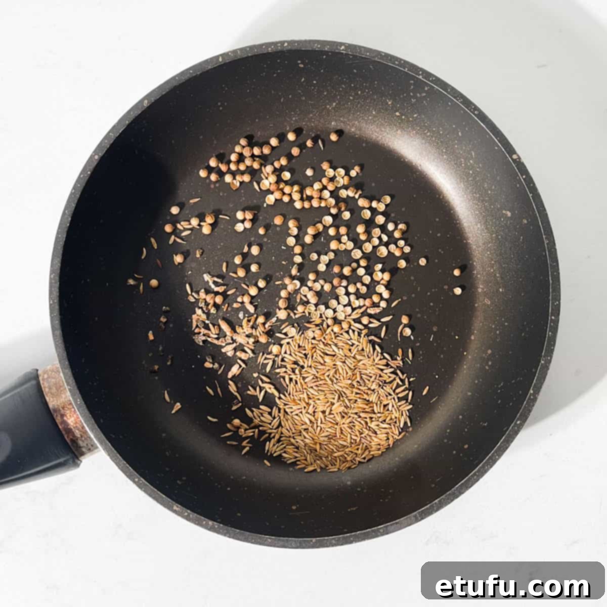 Spices for the Indian mango chutney toasting in a small frying pan.