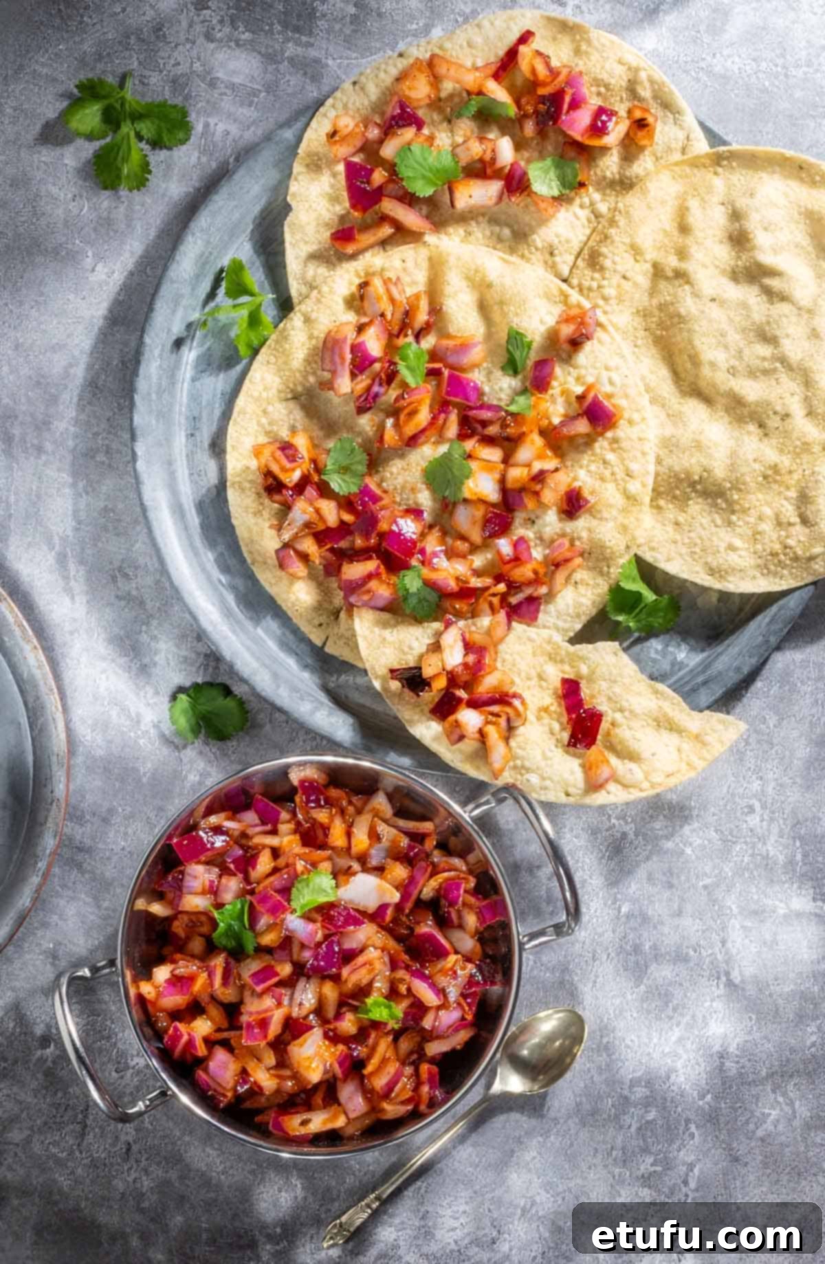 Poppadom Perfection: Indian Onion Chutney 2 Indian onion chutney spread over poppadoms on a grey background.