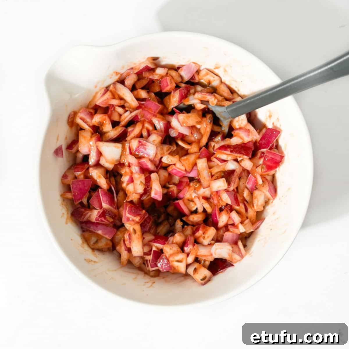 Poppadom Perfection: Indian Onion Chutney 11 Indian onion chutney, mixed together with the sauce in a white bowl.