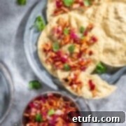 Poppadom Perfection: Indian Onion Chutney 12 Indian onion chutney spread over poppadoms on a grey background.