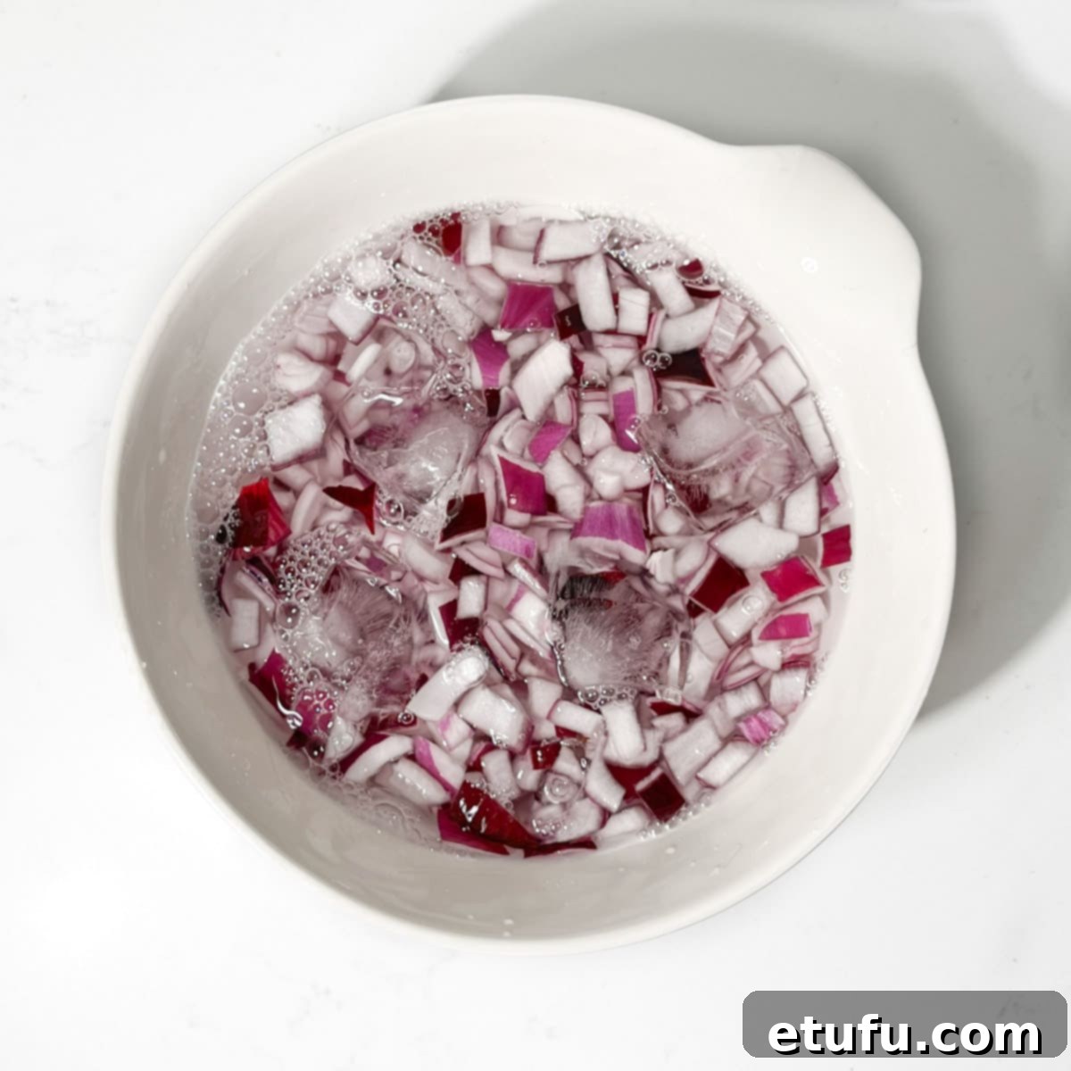 Poppadom Perfection: Indian Onion Chutney 5 Chopped onions soaking in a bowl of ice water.