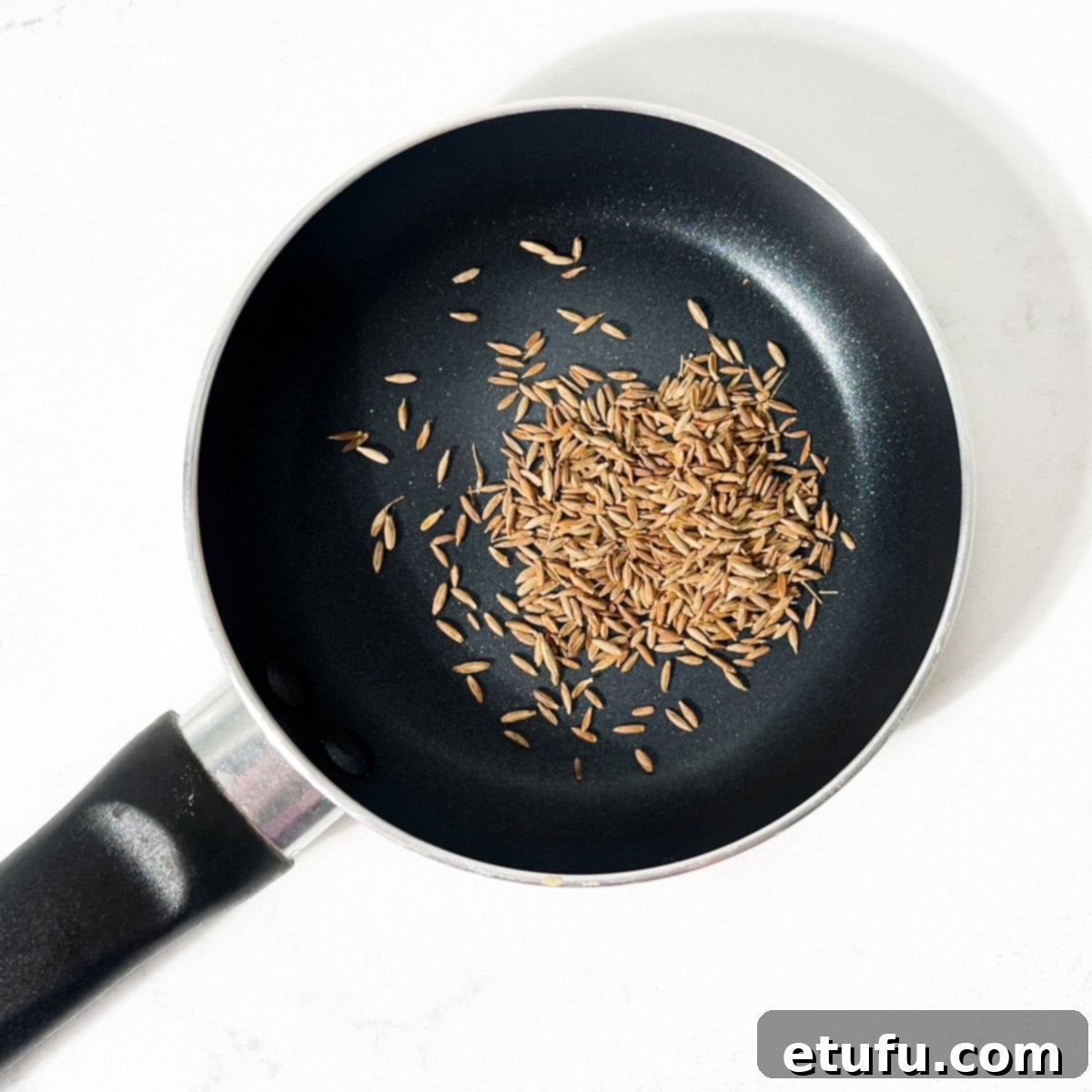 Poppadom Perfection: Indian Onion Chutney 6 Adding the cumin seeds for the Indian onion chutney to a small pan, ready for roasting.